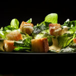 A Homemade Caesar Salad with fresh romaine, crunchy homemade croutons, and a tangy, creamy Parmesan dressing.