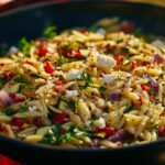 A photo showing a bowl of Lemon Garlic Orzo with roasted vegetables
