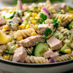 A photo showing a tuna pasta salad recipe in a bowl that's just been prepared.